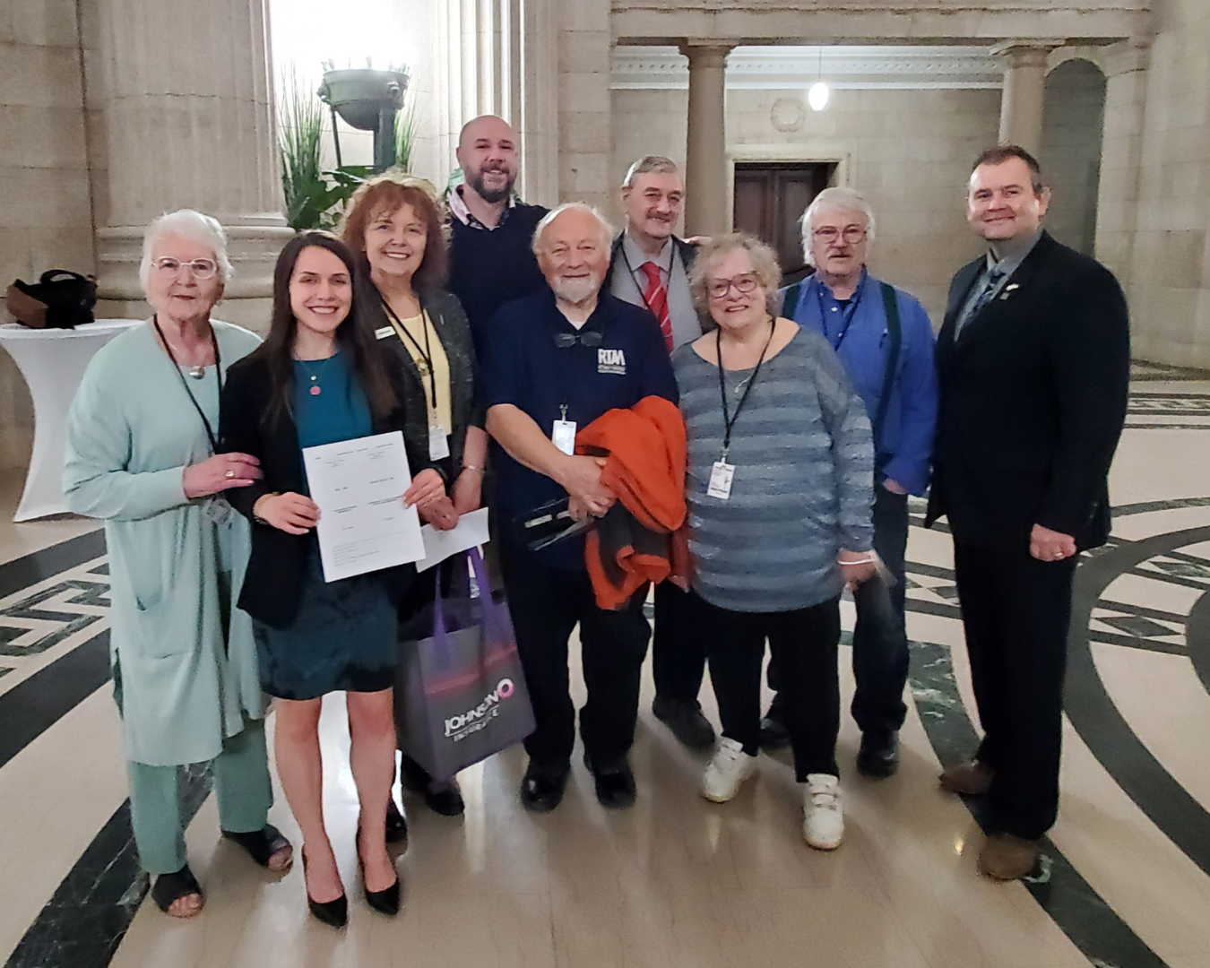 rtam-members-stand-in-manitoba-legislative-building